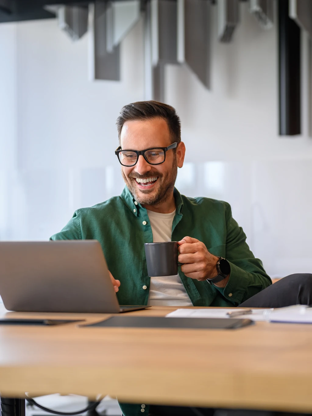 Man on a video call at a laptop in the office