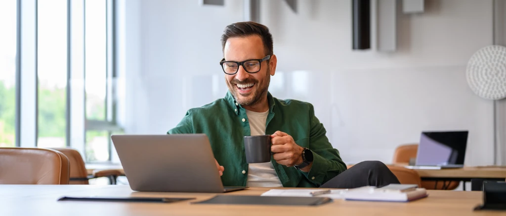 Man on a video call at a laptop in the office